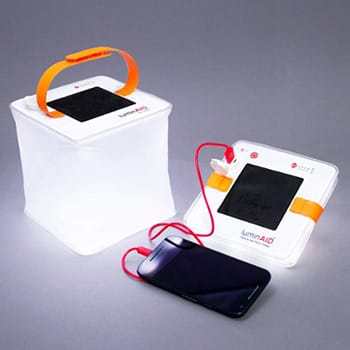 Two-inflatable-solar-lanterns-charging-a-mobile-phone